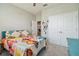 Bedroom with butterfly themed comforter set and double door closet at 32231 Conchshell Sail St, Wesley Chapel, FL 33545