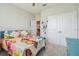 Bedroom with butterfly themed comforter set and double door closet at 32231 Conchshell Sail St, Wesley Chapel, FL 33545