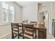 Dining room featuring natural light from a window and a four person wood table at 32231 Conchshell Sail St, Wesley Chapel, FL 33545