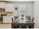 Open dining area with granite countertops, stainless steel appliances and shuttered window at 32231 Conchshell Sail St, Wesley Chapel, FL 33545
