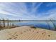 Dock overlooking a serene lake with calm waters, surrounded by waterfront homes and lush greenery at 32231 Conchshell Sail St, Wesley Chapel, FL 33545