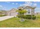 Well maintained exterior with a palm tree and stone accents, enhancing curb appeal at 32231 Conchshell Sail St, Wesley Chapel, FL 33545