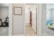 Hallway view to a bathroom and bedroom with tile floors and neutral colored walls at 32231 Conchshell Sail St, Wesley Chapel, FL 33545