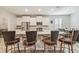 Bright kitchen with stainless appliances, granite countertops, and a large island with seating at 32231 Conchshell Sail St, Wesley Chapel, FL 33545