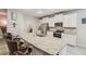 Modern kitchen with white cabinetry, granite countertops, stainless steel appliances, and a large island at 32231 Conchshell Sail St, Wesley Chapel, FL 33545