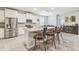 Bright, open kitchen with white cabinets, stainless steel appliances, and a granite island with bar seating at 32231 Conchshell Sail St, Wesley Chapel, FL 33545