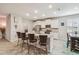 Well-lit kitchen featuring white cabinets, granite countertops, stainless steel appliances and center island at 32231 Conchshell Sail St, Wesley Chapel, FL 33545