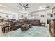 Open-concept living space with a large sectional sofa and views to the kitchen at 32231 Conchshell Sail St, Wesley Chapel, FL 33545