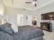 Spacious main bedroom featuring tray ceilings, a ceiling fan, and access to the main bathroom at 32231 Conchshell Sail St, Wesley Chapel, FL 33545