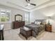 Serene bedroom with tray ceiling, neutral colors, and plantation shutters for a relaxing retreat at 32231 Conchshell Sail St, Wesley Chapel, FL 33545