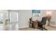 Home office or flex space featuring a wooden desk and neutral tile floors at 32231 Conchshell Sail St, Wesley Chapel, FL 33545