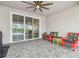 Covered patio features brick pavers and colorful chairs, perfect for relaxing or entertaining at 32231 Conchshell Sail St, Wesley Chapel, FL 33545