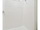 Bright shower stall with white tile, a shower head, and a window at 32231 Conchshell Sail St, Wesley Chapel, FL 33545