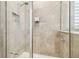 Modern tiled shower with glass enclosure and built-in niche at 32231 Conchshell Sail St, Wesley Chapel, FL 33545