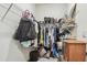 Walk-in closet with wire shelving, loaded with shoes, purses, and clothes at 32231 Conchshell Sail St, Wesley Chapel, FL 33545
