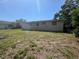 A view of the expansive backyard of the house and the exterior back of the house on a sunny day at 3308 E Frierson Ave, Tampa, FL 33610