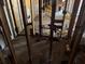 A view through interior studs to the other rooms of the house and discarded shopping carts at 3308 E Frierson Ave, Tampa, FL 33610