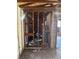 A view of an interior with exposed studs, pipes, and a hot water heater at 3308 E Frierson Ave, Tampa, FL 33610