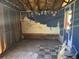 Run down room with painted wall, broken floor, and sticker-covered wall at 3308 E Frierson Ave, Tampa, FL 33610