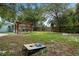 Backyard features a pergola, swing, and games for outdoor activities at 341 Wertz Dr, Largo, FL 33771