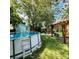 Backyard features an above ground pool, shed, firepit and pergola with swings at 341 Wertz Dr, Largo, FL 33771