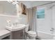 Bright bathroom with a stylish vanity, bathtub with shower, and pineapple art at 341 Wertz Dr, Largo, FL 33771