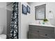 Stylish bathroom featuring a shower with tiled walls, vanity with modern sink, and elegant decor at 341 Wertz Dr, Largo, FL 33771