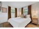 Bright bedroom featuring two windows with decorative curtains, and neutral decor at 341 Wertz Dr, Largo, FL 33771