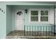 Inviting front porch with decorative railing, offering a warm welcome with its charming details and well-kept appearance at 341 Wertz Dr, Largo, FL 33771