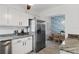Bright kitchen with stainless steel refrigerator and a cozy dining area with blue themed wallpaper at 341 Wertz Dr, Largo, FL 33771