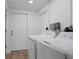 Bright laundry room featuring a washer and dryer with an exterior door at 341 Wertz Dr, Largo, FL 33771