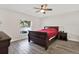 This bedroom features wood flooring, a ceiling fan, and a window for natural light at 3613 21St S Ave, St Petersburg, FL 33711