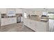 Modern kitchen featuring white cabinets, granite countertops, stainless steel appliances, and wood flooring at 3613 21St S Ave, St Petersburg, FL 33711
