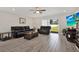 Comfortable living room featuring plush sofas, hardwood flooring, and a sliding glass door to the backyard at 3613 21St S Ave, St Petersburg, FL 33711