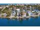 Stunning aerial view of waterfront homes with private docks on a sunny day near calm blue water at 443 18Th Ave, Indian Rocks Beach, FL 33785