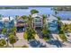 Aerial view of luxurious waterfront homes showcasing lush landscaping, private docks, and stunning water access at 443 18Th Ave, Indian Rocks Beach, FL 33785