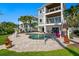 Lush backyard featuring a sparkling pool, spa, manicured lawn, and balconies offering scenic outdoor living spaces at 443 18Th Ave, Indian Rocks Beach, FL 33785