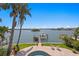 Backyard features lush landscaping, a private dock, and stunning waterfront views at 443 18Th Ave, Indian Rocks Beach, FL 33785