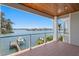 Wide angle shot of brick balcony overlooking waterfront with boat dock and boat lift at 443 18Th Ave, Indian Rocks Beach, FL 33785