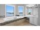 Elegant bathroom with a soaking tub, stunning water views, and ample natural light at 443 18Th Ave, Indian Rocks Beach, FL 33785