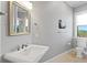 Well-lit bathroom features a stylish mirror, a modern sink, and a window offering natural light at 443 18Th Ave, Indian Rocks Beach, FL 33785