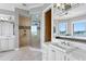 Well-lit bathroom with a glass shower, double sink vanity, and waterfront views at 443 18Th Ave, Indian Rocks Beach, FL 33785