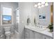 Bright bathroom with a window, white vanity and drawers, and glass enclosed shower at 443 18Th Ave, Indian Rocks Beach, FL 33785