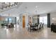 Open-concept dining room with a modern chandelier and views of the living area and waterfront at 443 18Th Ave, Indian Rocks Beach, FL 33785