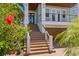Charming two-story home with a brick driveway, stairs to the front door and lush landscaping at 443 18Th Ave, Indian Rocks Beach, FL 33785