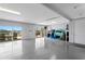 Spacious garage with epoxy flooring, water access, and ample storage space for recreational equipment at 443 18Th Ave, Indian Rocks Beach, FL 33785