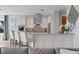 Kitchen features a large island with seating, stainless steel appliances, and elegant white cabinetry at 443 18Th Ave, Indian Rocks Beach, FL 33785