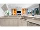 Open kitchen with water view, kitchen island, stainless steel appliances and view of the living room at 443 18Th Ave, Indian Rocks Beach, FL 33785