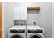 Bright laundry room with modern appliances, cabinets and hanging rack for clothes at 443 18Th Ave, Indian Rocks Beach, FL 33785
