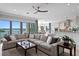 Inviting living room with a comfortable sectional sofa, stone fireplace, and stunning waterfront views at 443 18Th Ave, Indian Rocks Beach, FL 33785